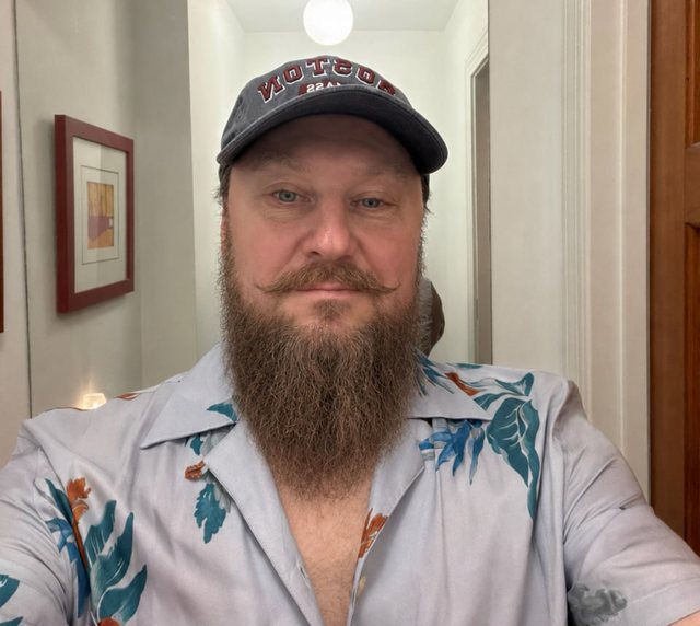 Photograph of Serg Parf in a Boston cap and a patterned shirt.